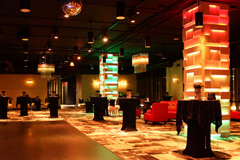 vibrant LED hues of oranges, yellows and greens on columns and room in The MEZZ at Sanctuary Condo Tower, Orlando, Florida USA