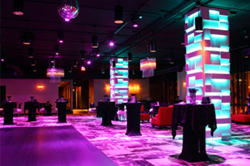 vibrant LED hues of magenta and aqua on columns and room in The MEZZ at Sanctuary Condo Tower, Orlando, Florida USA