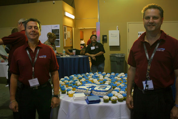 Techni-Lux President Luciano Salvati and Vice President Alex Gonzalez in front of 20th cake and cupcakesTechni-Lux 20th Anniversary Open House, Orlando, Florida