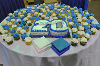 close up of the 20th vanilla sheet cake with white buttercream frosting with blue and silver piping, White frosting and blue frosting chocolate and vanilla cupcakes 20th Anniversary Open House 2010, Orlando, Florida USA