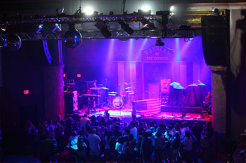 crowd gathered watching concert on stage lights on stage blue and magenta beams of LED and blue beams on the crowd and onThe Beacham - Orlando, Florida, USA