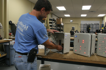 Techni-Lux technician Bruce working on custom blink box for Interactive dark ride Justice League: Battle For Metropolis 4D at Six Flags Theme Park, U.S.A.