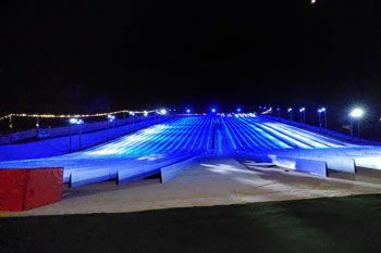 synched to music LED light show with hues of blue, aqua and white on Snowy Slopes at Snowcat Ridge Alpine Snow Park - Dade City, Florida, USA