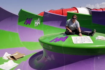 Consultant Lisa Hansen applying vinyl transfers on the Batman™ Water Slide, Parque Warner Beach - Madrid, Spain