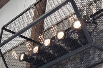 mulitple ellipsoidal fixtures protected in metal cage in Gymnatorium at Martin Luther King Jr. Junior High, Monroe, Louisiana, USA